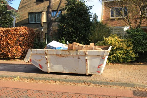 Team removing green waste from a garden in Palmersgreen